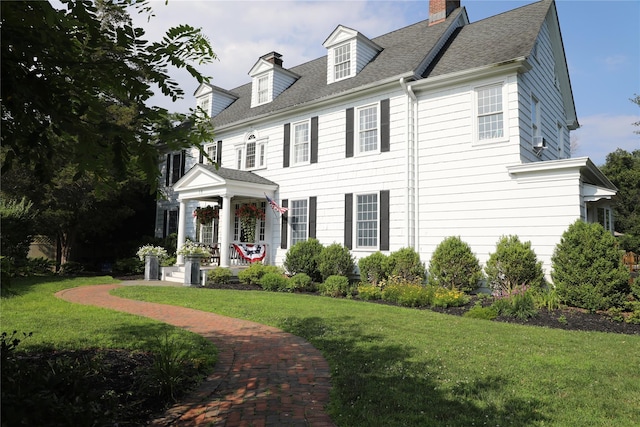 15 Abbey Crk, East Islip, NY 11730 - view of front of property with a front lawn, a chimney, and roof with shingles