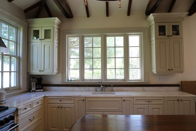 15 Abbey Crk, East Islip, NY 11730 - kitchen featuring beam ceiling, healthy amount of natural light, and glass insert cabinets