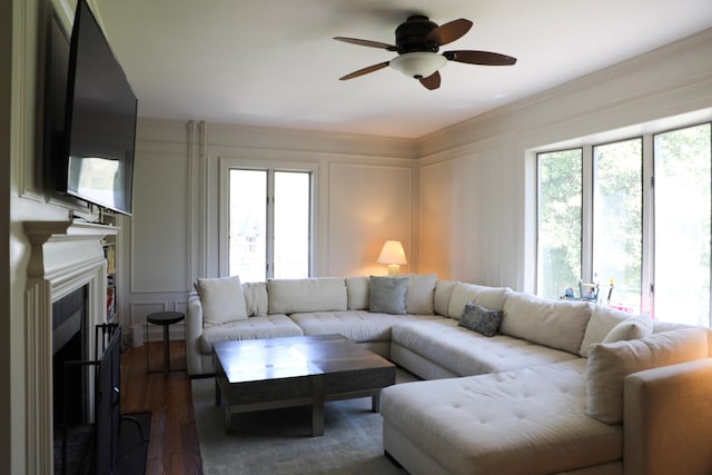 15 Abbey Crk, East Islip, NY 11730 - living area with a decorative wall, plenty of natural light, a ceiling fan, dark wood-style flooring, and a fireplace