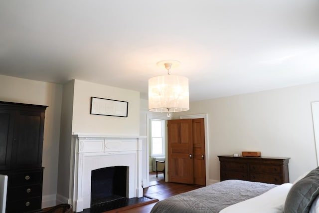 15 Abbey Crk, East Islip, NY 11730 - bedroom featuring a fireplace and dark wood-type flooring