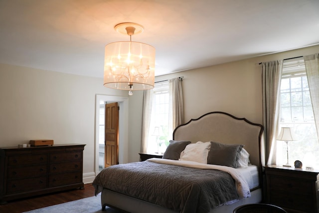 15 Abbey Crk, East Islip, NY 11730 - bedroom with a chandelier and dark wood-type flooring