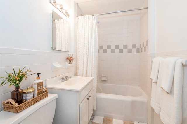 99-21 67th Rd Unit 4D, Forest Hills, NY 11375 - bathroom with vanity, shower / bathtub combination with curtain, tile walls, and wainscoting