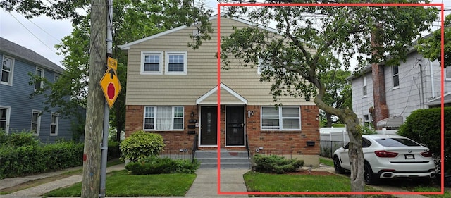 13834 247th St, Rosedale, NY 11422 - view of front facade featuring brick siding