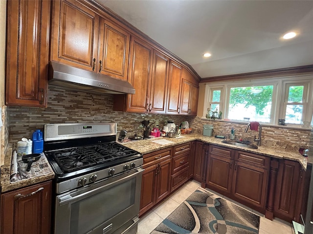 56 Helena Ave, Yonkers, NY 10710 - kitchen with gas stove, under cabinet range hood, backsplash, light stone counters, and light tile patterned flooring