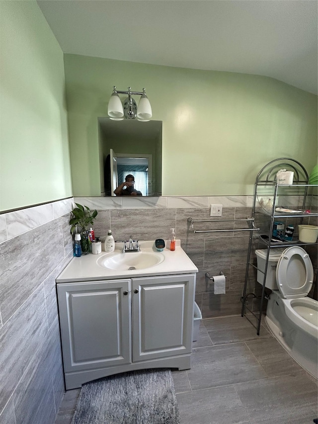 56 Helena Ave, Yonkers, NY 10710 - bathroom featuring tile walls, vanity, wainscoting, and tile patterned flooring