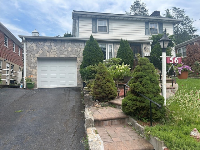 56 Helena Ave, Yonkers, NY 10710 - view of front of house featuring a garage, driveway, a chimney, and stone siding