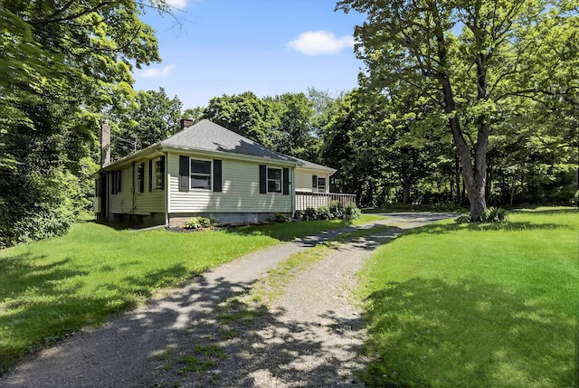 11 Tribune Ln, Red Hook, NY 12571 - view of home's exterior with a chimney, a lawn, and driveway