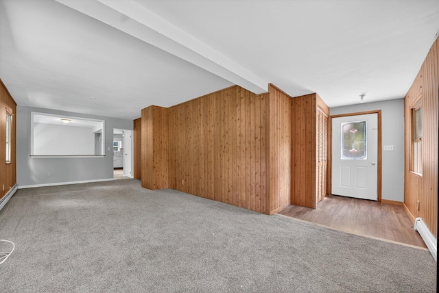 11 Tribune Ln, Red Hook, NY 12571 - unfurnished living room featuring plenty of natural light, carpet, wooden walls, and beamed ceiling
