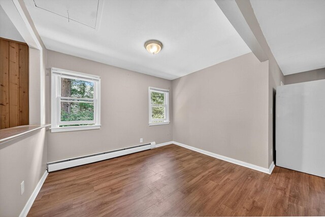 11 Tribune Ln, Red Hook, NY 12571 - spare room with a baseboard heating unit, attic access, wood finished floors, and healthy amount of natural light