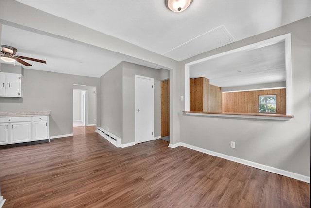 11 Tribune Ln, Red Hook, NY 12571 - unfurnished living room featuring attic access, a baseboard radiator, dark wood-style floors, and ceiling fan