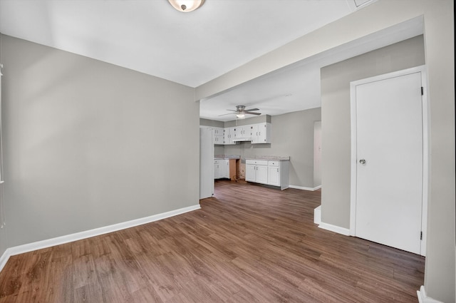 11 Tribune Ln, Red Hook, NY 12571 - unfurnished living room with a ceiling fan and dark wood-style flooring