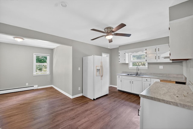 11 Tribune Ln, Red Hook, NY 12571 - kitchen with white refrigerator with ice dispenser, baseboard heating, ceiling fan, white cabinets, and dark wood finished floors