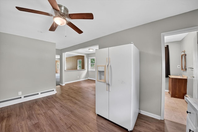 11 Tribune Ln, Red Hook, NY 12571 - kitchen featuring white fridge with ice dispenser, a baseboard radiator, ceiling fan, and wood finished floors
