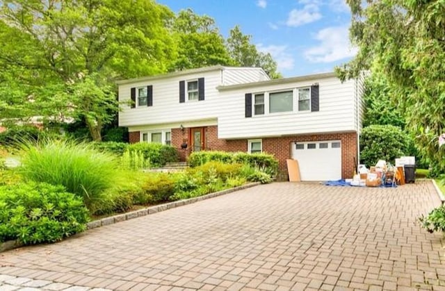50 Chester Dr, Yonkers, NY 10710 - tri-level home with brick siding, a garage, and decorative driveway