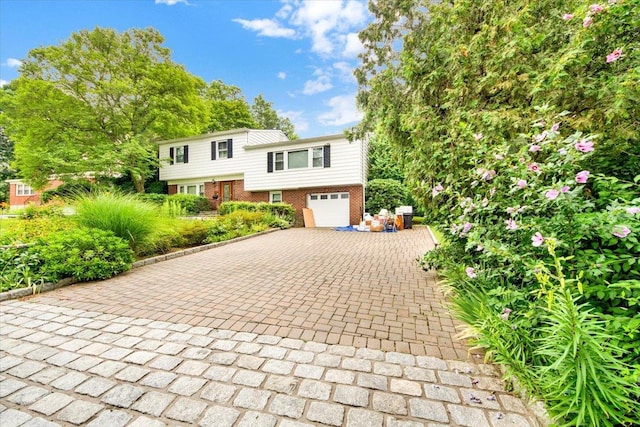50 Chester Dr, Yonkers, NY 10710 - view of front of home featuring decorative driveway, brick siding, and a garage