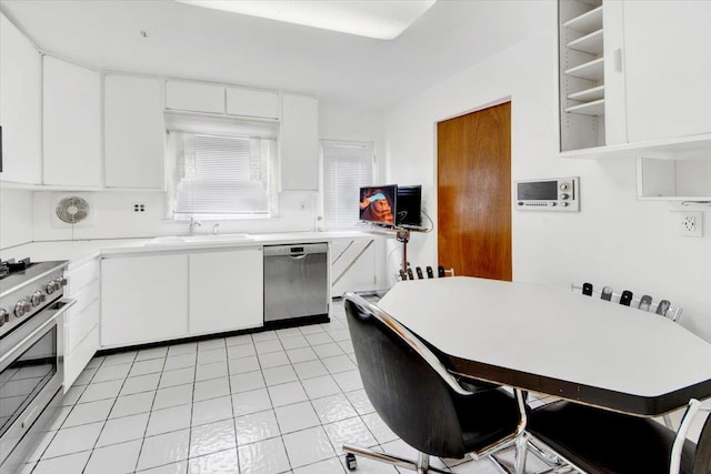 50 Chester Dr, Yonkers, NY 10710 - kitchen with appliances with stainless steel finishes, white cabinets, light countertops, and light tile patterned flooring