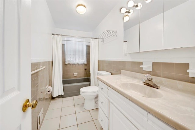 50 Chester Dr, Yonkers, NY 10710 - bathroom with tile patterned floors, tile walls, vanity, shower / tub combo, and wainscoting