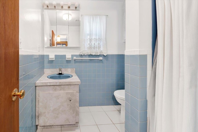 50 Chester Dr, Yonkers, NY 10710 - full bath with tile walls, vanity, tile patterned floors, wainscoting, and curtained shower