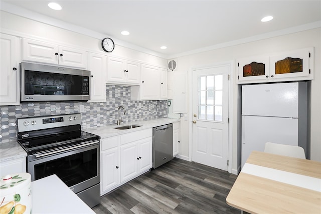 16 Primrose Ln, Levittown, NY 11756 - kitchen with stainless steel appliances, light countertops, white cabinetry, backsplash, and recessed lighting