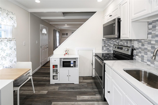 16 Primrose Ln, Levittown, NY 11756 - kitchen with stainless steel appliances, backsplash, recessed lighting, white cabinets, and dark wood-style floors