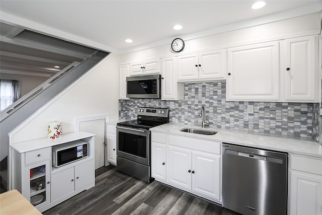 16 Primrose Ln, Levittown, NY 11756 - kitchen featuring stainless steel appliances, tasteful backsplash, white cabinetry, dark wood finished floors, and light stone countertops
