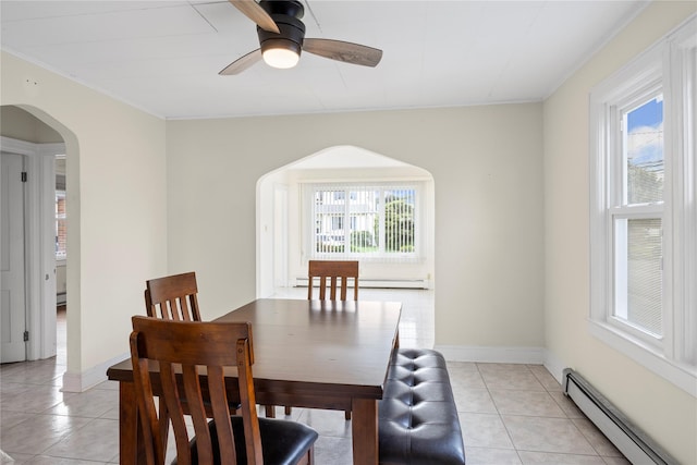 178 Charles St, Lynbrook, NY 11563 - dining space featuring a baseboard heating unit, healthy amount of natural light, ornamental molding, and arched walkways