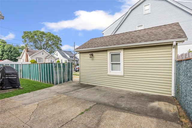 178 Charles St, Lynbrook, NY 11563 - view of property exterior featuring roof with shingles and a patio area