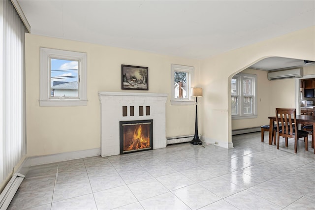 178 Charles St, Lynbrook, NY 11563 - living area featuring a wall mounted air conditioner, baseboard heating, arched walkways, and a brick fireplace