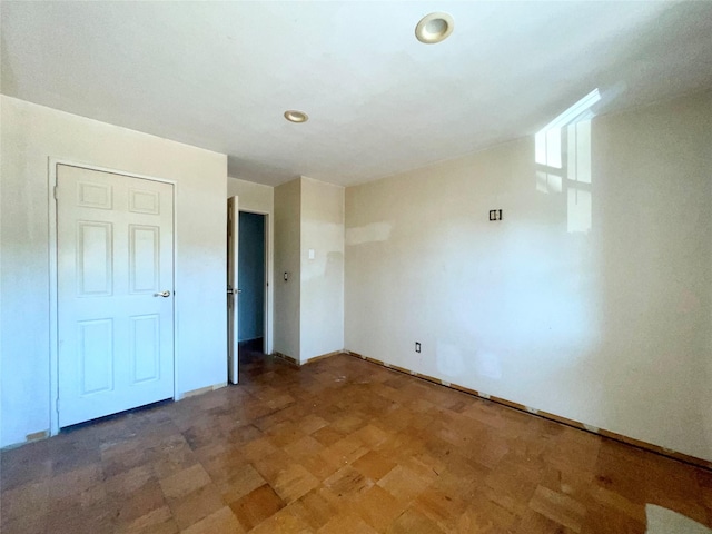 100 Connetquot Ave Unit 10, East Islip, NY 11730 - unfurnished bedroom featuring recessed lighting and baseboards