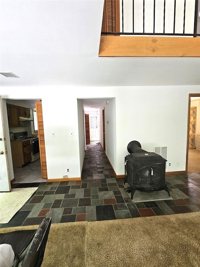 2 Redmond Way, Stanfordville, NY 12581 - living room with a wood stove, a towering ceiling, and dark carpet