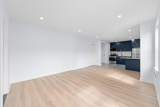 37-56 87th St Unit 3C, Jackson Heights, NY 11372 - unfurnished living room with light wood-type flooring and recessed lighting