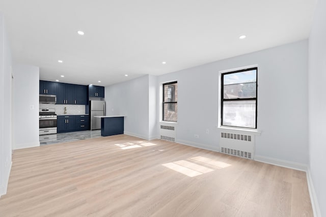 37-56 87th St Unit 3C, Jackson Heights, NY 11372 - unfurnished living room with radiator, light wood finished floors, and recessed lighting
