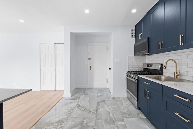 37-56 87th St Unit 3C, Jackson Heights, NY 11372 - kitchen with stainless steel appliances, blue cabinetry, decorative backsplash, recessed lighting, and light marble finish flooring