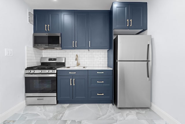 37-56 87th St Unit 3C, Jackson Heights, NY 11372 - kitchen with stainless steel appliances, blue cabinetry, light countertops, backsplash, and light marble finish flooring