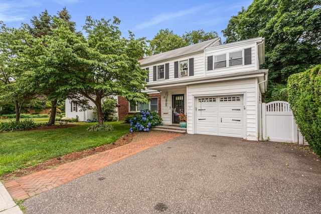 21 Orchard St, Glen Head, NY 11545 - traditional home with a garage, a front lawn, driveway, and a gate