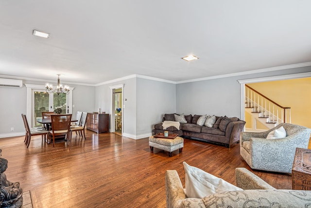 21 Orchard St, Glen Head, NY 11545 - living area with a chandelier, a wall mounted air conditioner, wood finished floors, ornamental molding, and stairway