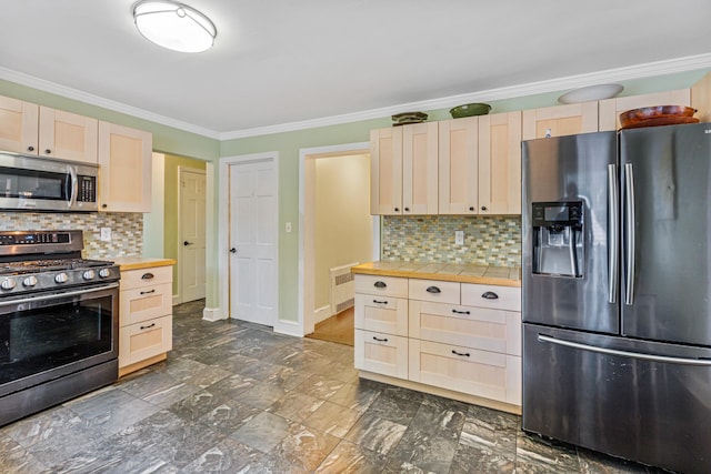 21 Orchard St, Glen Head, NY 11545 - kitchen featuring appliances with stainless steel finishes, light brown cabinetry, crown molding, decorative backsplash, and tile countertops