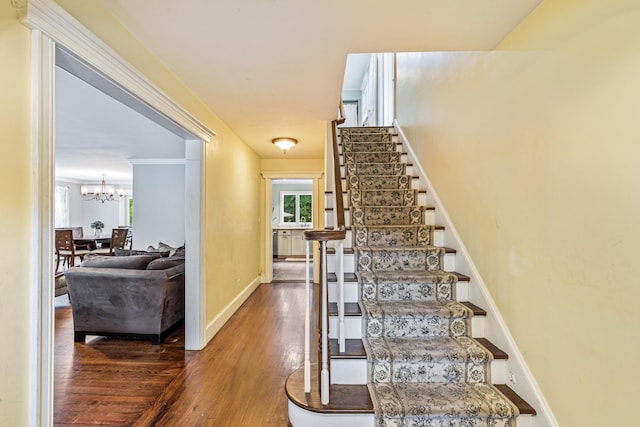 21 Orchard St, Glen Head, NY 11545 - stairway with wood finished floors, a chandelier, and healthy amount of natural light