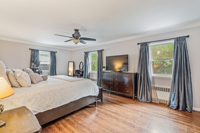 21 Orchard St, Glen Head, NY 11545 - bedroom featuring radiator heating unit, wood finished floors, ornamental molding, ceiling fan, and cooling unit