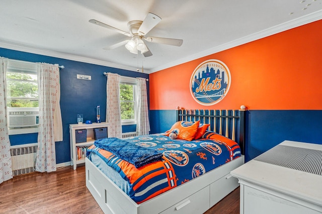 21 Orchard St, Glen Head, NY 11545 - bedroom with radiator, wood finished floors, cooling unit, ornamental molding, and ceiling fan