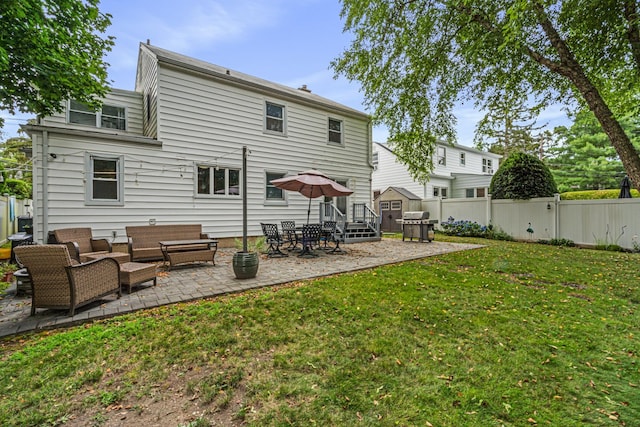 21 Orchard St, Glen Head, NY 11545 - back of property featuring a patio, a fenced backyard, and outdoor lounge area