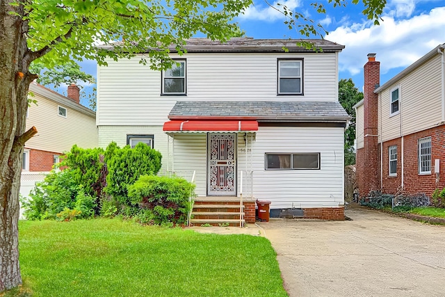 56-28 213th St, Bayside, NY 11364 - view of front of property with a front lawn and a high end roof