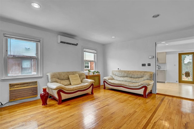 56-28 213th St, Bayside, NY 11364 - living room with a wall unit AC, light wood-style flooring, recessed lighting, a wall mounted air conditioner, and heating unit
