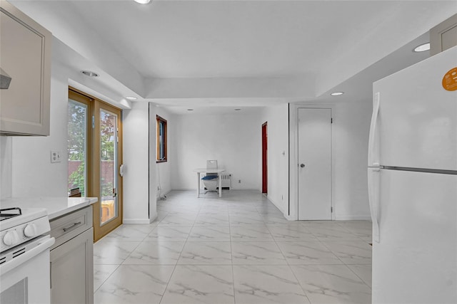 56-28 213th St, Bayside, NY 11364 - kitchen with white appliances, recessed lighting, light marble finish flooring, light countertops, and radiator