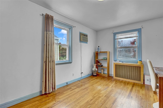 56-28 213th St, Bayside, NY 11364 - unfurnished room with radiator, light wood-style floors, and a wall mounted AC
