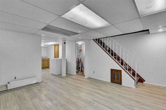 56-28 213th St, Bayside, NY 11364 - finished below grade area with washer / clothes dryer, stairs, light wood finished floors, and a drop ceiling