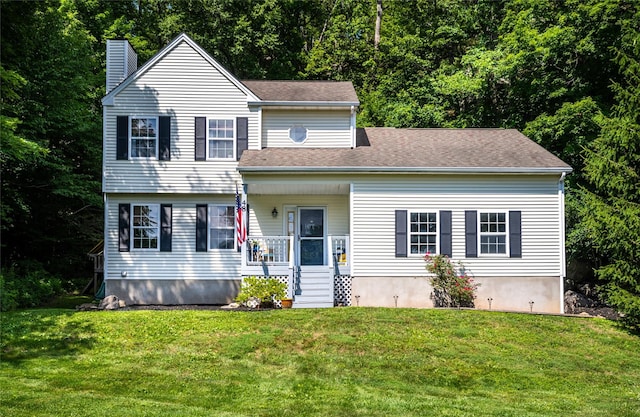 48 Devon Rd, Patterson, NY 12563 - view of front of house featuring a chimney, covered porch, and a front lawn