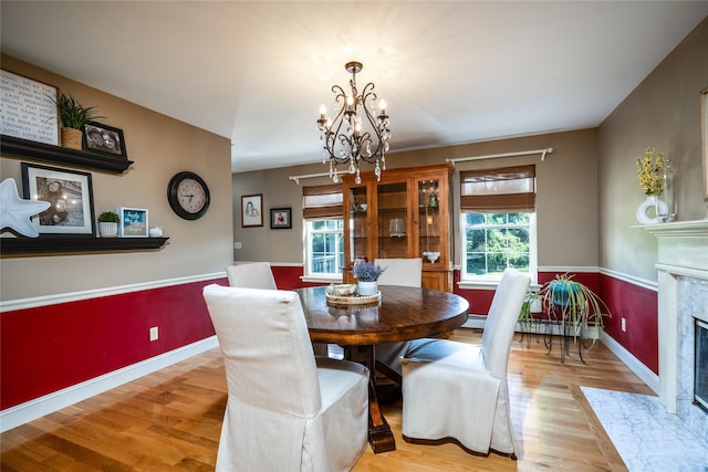48 Devon Rd, Patterson, NY 12563 - dining space with plenty of natural light, a high end fireplace, a chandelier, and light wood-type flooring
