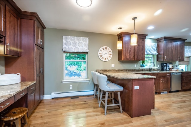 48 Devon Rd, Patterson, NY 12563 - kitchen with a baseboard heating unit, dishwasher, light wood finished floors, a kitchen bar, and light stone countertops