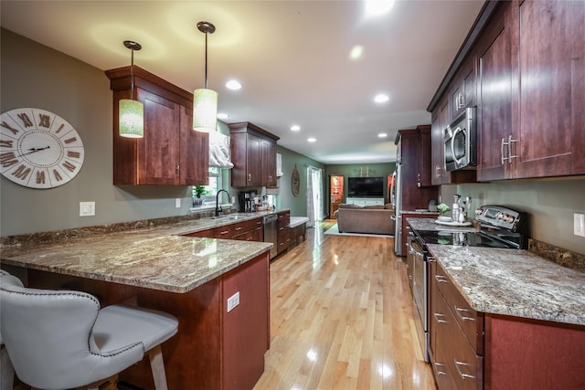 48 Devon Rd, Patterson, NY 12563 - kitchen with stainless steel appliances, a peninsula, open floor plan, light stone counters, and recessed lighting